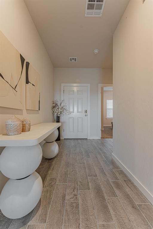 bathroom with baseboards, visible vents, and wood finish floors