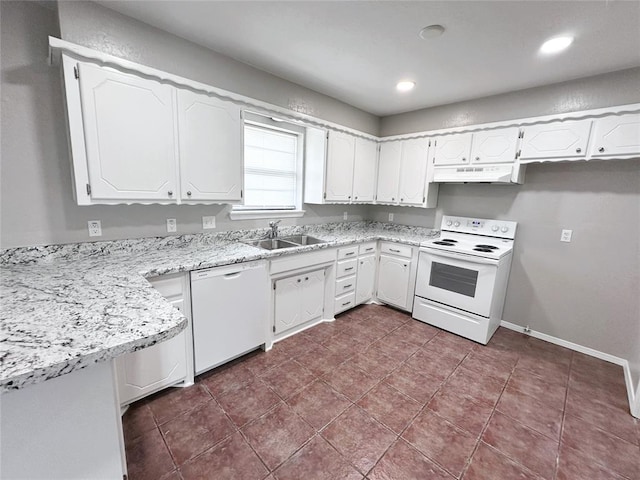 kitchen featuring sink, white cabinets, dark tile patterned floors, light stone counters, and white appliances