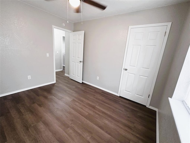 unfurnished bedroom with ceiling fan and dark hardwood / wood-style flooring