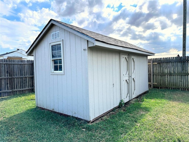 view of outdoor structure with a lawn