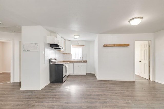 kitchen featuring dark wood-type flooring, stainless steel range with electric stovetop, sink, and white cabinets