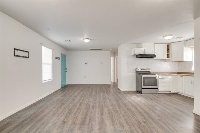 kitchen with tasteful backsplash, hardwood / wood-style floors, stainless steel electric range, and white cabinets