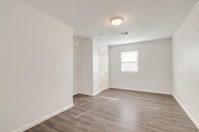 unfurnished room with dark hardwood / wood-style floors