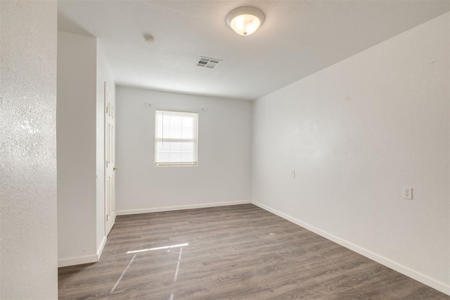 unfurnished room with dark hardwood / wood-style floors