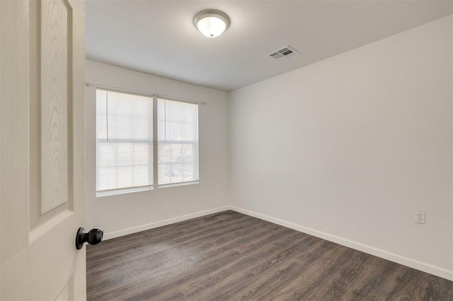 empty room with dark hardwood / wood-style floors