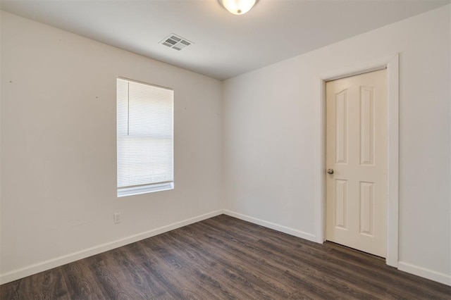 spare room featuring dark hardwood / wood-style flooring