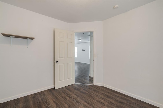 empty room featuring dark wood-type flooring