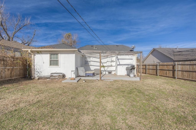 rear view of house with a lawn and a patio