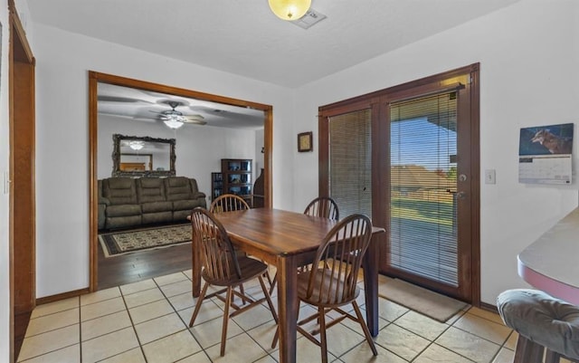 tiled dining room with ceiling fan