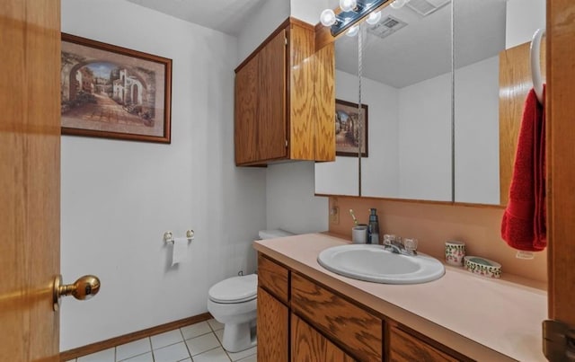 bathroom featuring vanity, tile patterned floors, and toilet