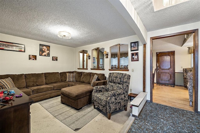 carpeted living room featuring a textured ceiling