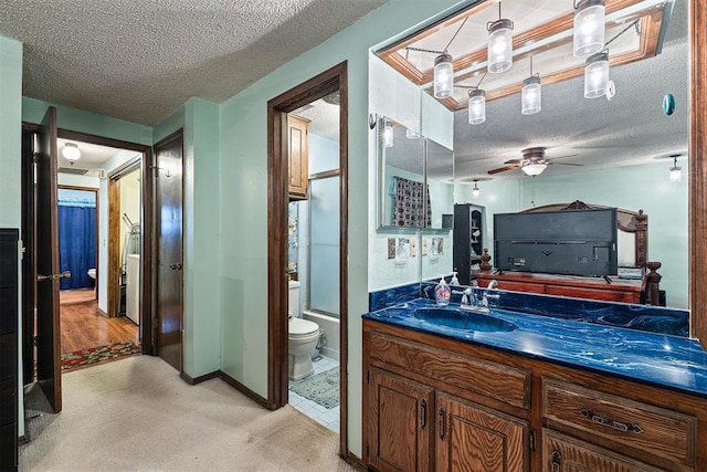 full bathroom featuring vanity, a textured ceiling, and toilet