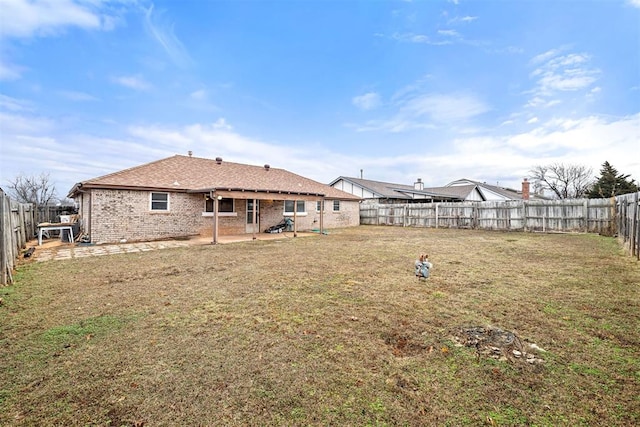 rear view of house with a yard