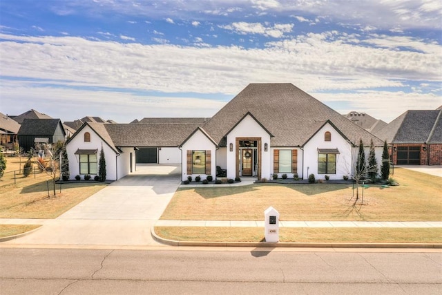 view of front facade featuring driveway, a front lawn, and roof with shingles