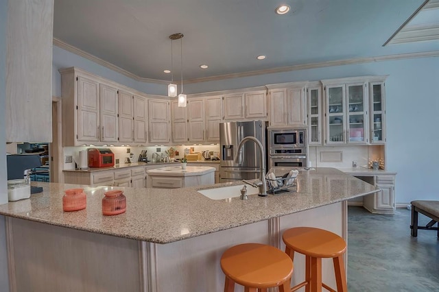 kitchen with crown molding, a breakfast bar, hanging light fixtures, stainless steel appliances, and light stone countertops