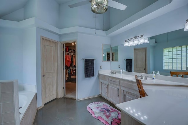 bathroom with high vaulted ceiling, concrete floors, vanity, a bathing tub, and ceiling fan