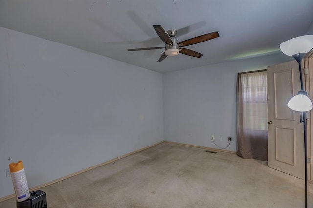 carpeted spare room featuring ceiling fan