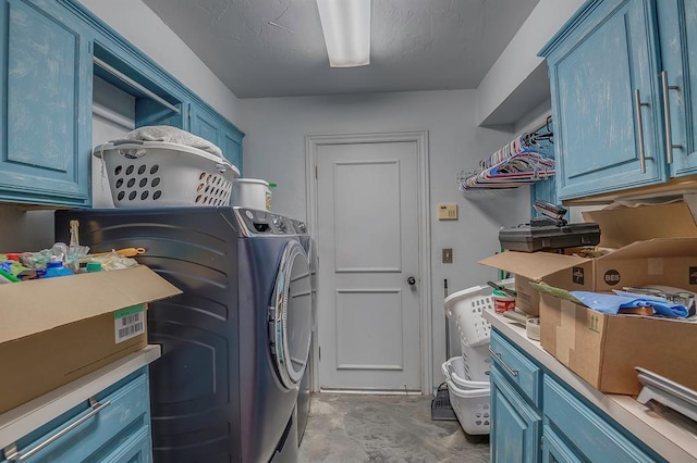 clothes washing area featuring cabinets and independent washer and dryer