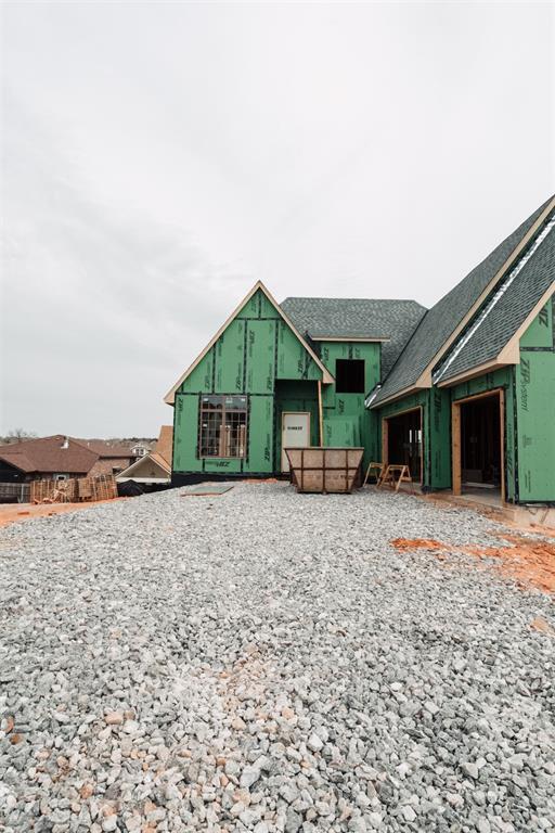 view of front of home with roof with shingles