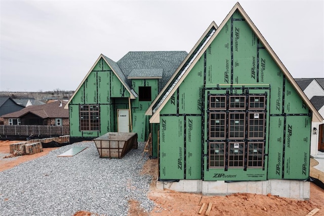 unfinished property featuring roof with shingles