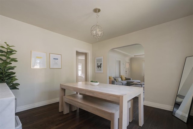 dining room with dark wood-type flooring and a chandelier