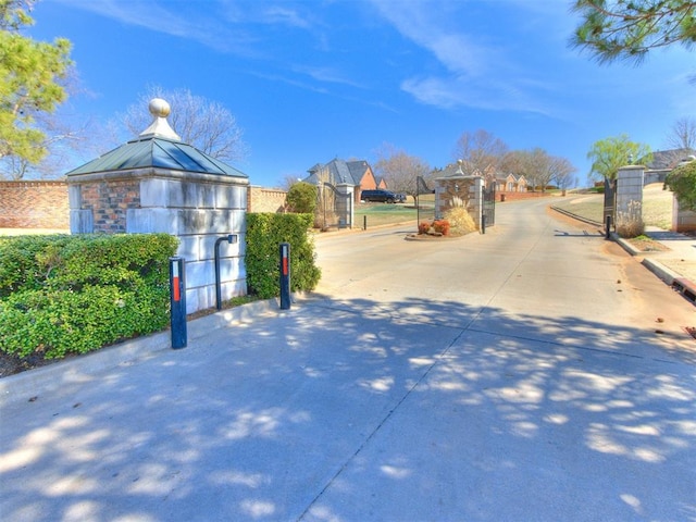817 Carrie Ct, Purcell, OK 73080 - view of street with a gate, curbs, and a gated entry