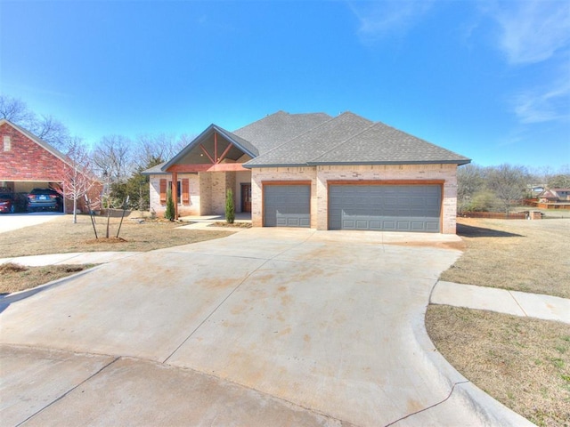 view of front of home featuring a garage, brick siding, concrete driveway, and a shingled roof