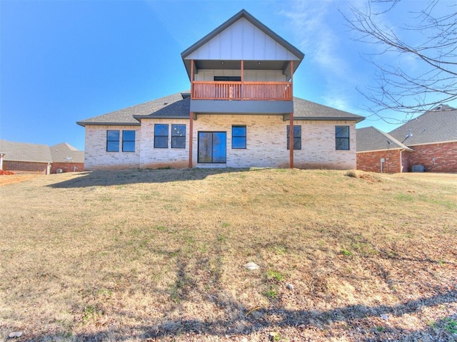 817 Carrie Ct, Purcell, OK 73080 - back of property featuring brick siding, a balcony, a lawn, and board and batten siding