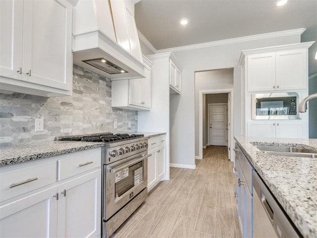 817 Carrie Ct, Purcell, OK 73080 - kitchen featuring premium range hood, ornamental molding, a sink, appliances with stainless steel finishes, and white cabinets