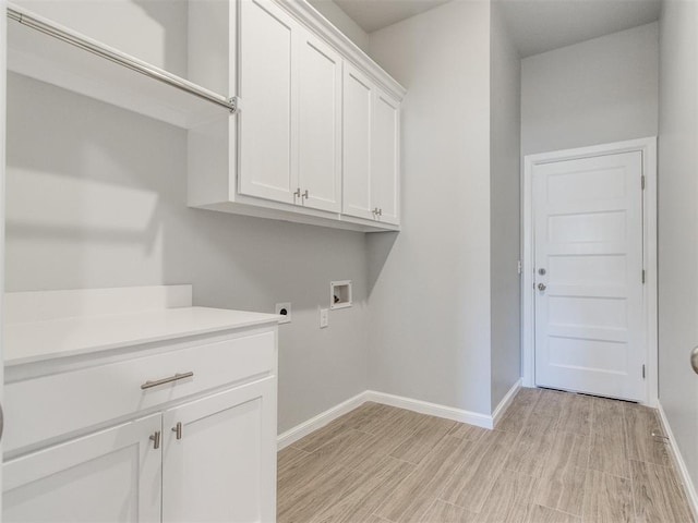 817 Carrie Ct, Purcell, OK 73080 - clothes washing area featuring baseboards, hookup for an electric dryer, cabinet space, washer hookup, and light wood-style floors