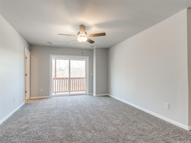 817 Carrie Ct, Purcell, OK 73080 - spare room with visible vents, carpet floors, baseboards, and a ceiling fan
