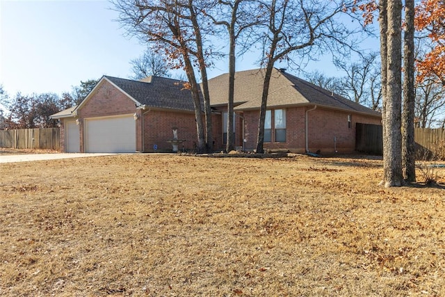 ranch-style house featuring a garage and a front yard