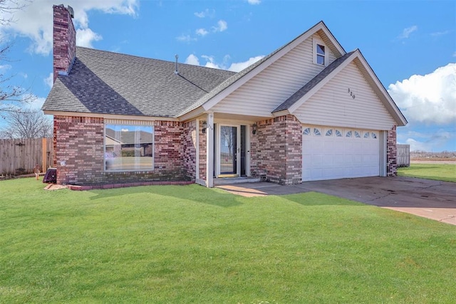 view of front of house featuring a chimney, an attached garage, fence, a front lawn, and brick siding