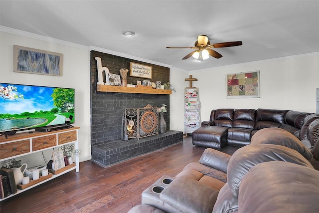 living area with a fireplace, ornamental molding, and dark wood-type flooring