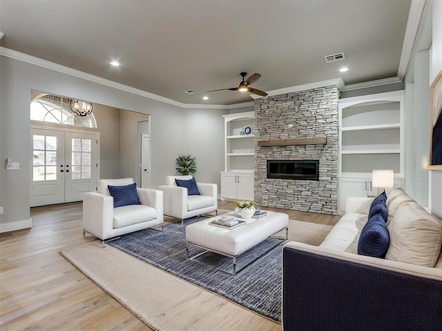3134 NW 37th St, Newcastle, OK 73065 - living area featuring ornamental molding, light wood-type flooring, ceiling fan, a fireplace, and built in features