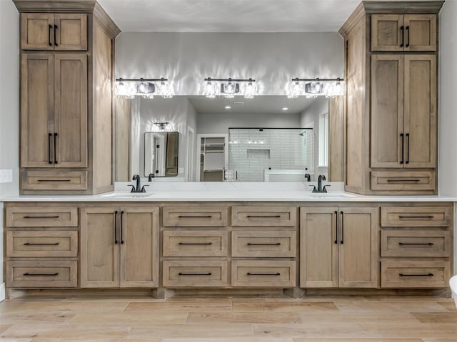3134 NW 37th St, Newcastle, OK 73065 - bathroom featuring a tile shower, double vanity, and wood finished floors