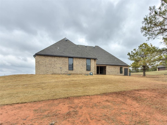 3134 NW 37th St, Newcastle, OK 73065 - rear view of house featuring a shingled roof, a yard, and brick siding