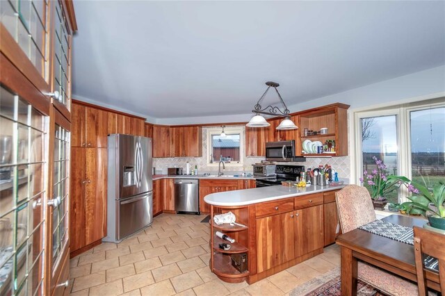 1901 E 15th St, Chandler, OK 74834 - kitchen featuring stainless steel appliances, open shelves, a peninsula, and decorative backsplash