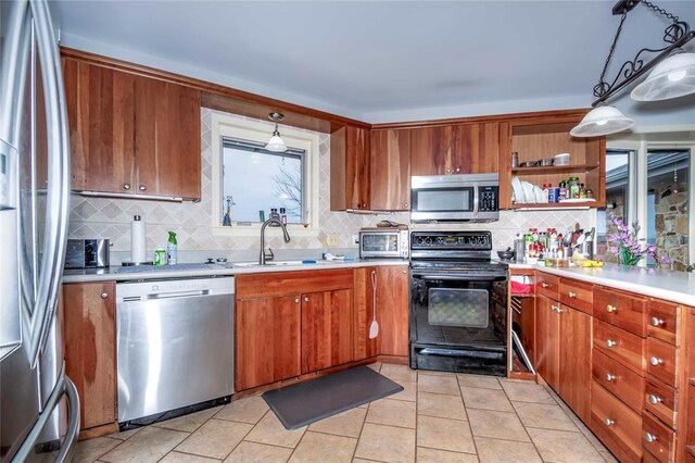 1901 E 15th St, Chandler, OK 74834 - kitchen with appliances with stainless steel finishes, a sink, backsplash, and light countertops