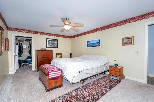 1901 E 15th St, Chandler, OK 74834 - carpeted bedroom with a walk in closet, a closet, baseboards, and ceiling fan