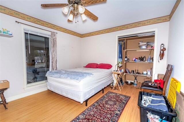 1901 E 15th St, Chandler, OK 74834 - bedroom featuring wood finished floors, a ceiling fan, and baseboards