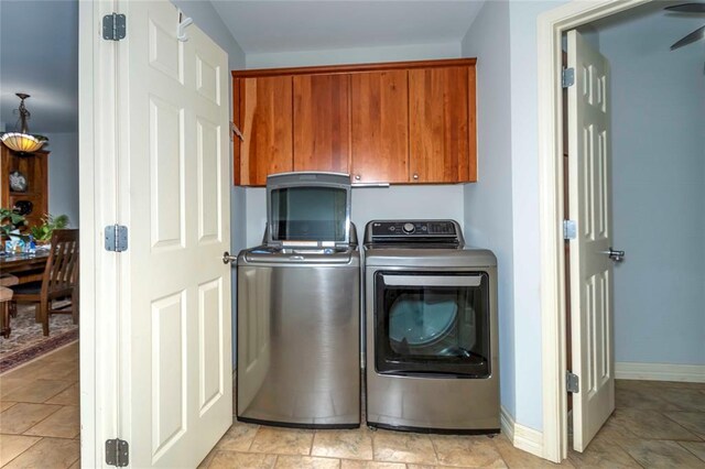 1901 E 15th St, Chandler, OK 74834 - washroom featuring cabinet space, washing machine and clothes dryer, baseboards, and light stone finish floors