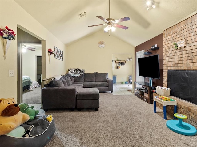 living room with ceiling fan, a brick fireplace, vaulted ceiling, and light carpet