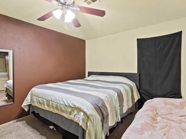 bedroom with ceiling fan and dark colored carpet