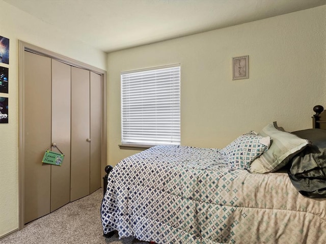 bedroom featuring light colored carpet and a closet