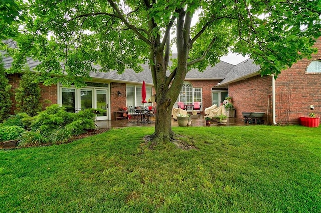 rear view of house featuring a yard, an outdoor living space, and a patio area