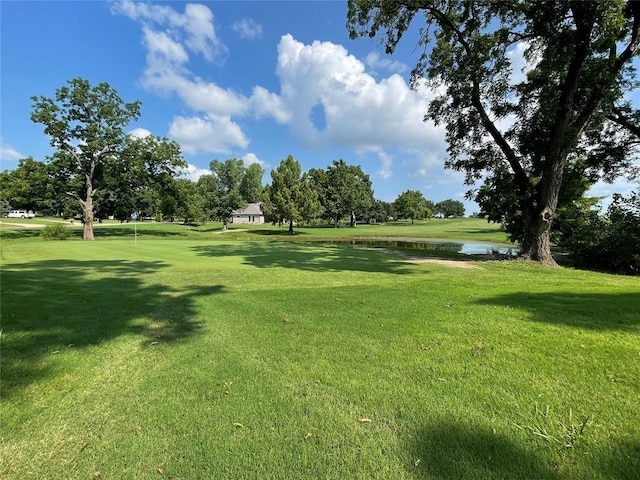 view of home's community featuring a yard and a water view