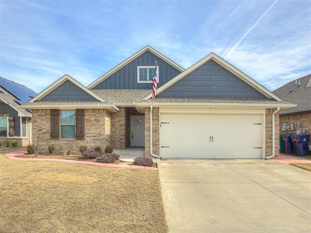 craftsman-style house featuring a garage and a front yard