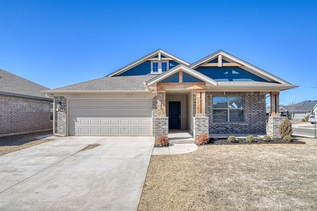 view of front of home with concrete driveway, brick siding, an attached garage, and roof with shingles