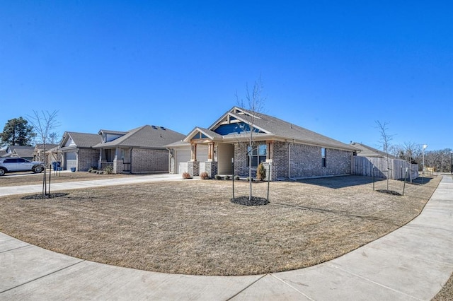 view of front of house with a garage, driveway, and brick siding